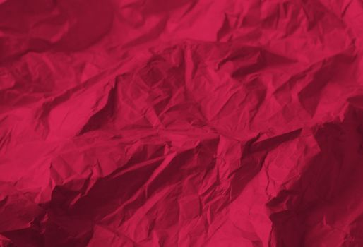 Crumpled paper Viva Magenta color of the year 2023. Texture crumpled paper for your design. Copy space. Viva Magenta color paper. High quality photo