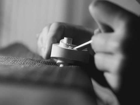 violinmaker working on a handmade contemporary stringed instrument scroll