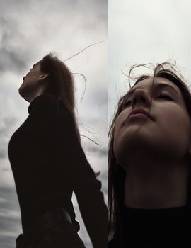 a teenage girl stands alone in nature in the evening under the wind and breathes fresh air thinking about fate is not easy and hard gloomy photo. High quality photo