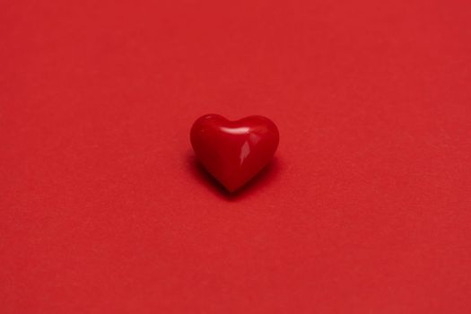 Valentines day red heart on same color background. Monochromatic vivid color. Valentine's day concept. Close up, copy space