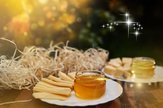 a jar of sweet honey with cheese and roses and fresh bread with bright light beautiful decoration creative photo in a bucket on a wooden table in the garden with flowers for breakfast delicious food. High quality photo