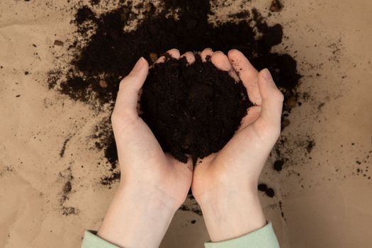 Soil in hands.National soil day. Earth day concept. Care about earth. Transplantation plant.