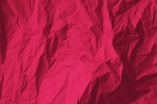 Crumpled paper Viva Magenta color of the year 2023. Texture crumpled paper for your design. Copy space. Viva Magenta color paper. High quality photo