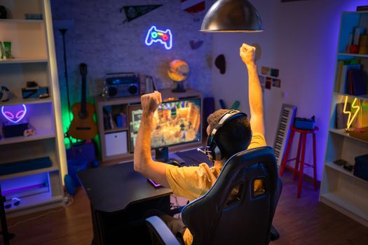 Professional Gamer winning and celebrating victory Online Video Game on Computer . High quality photo