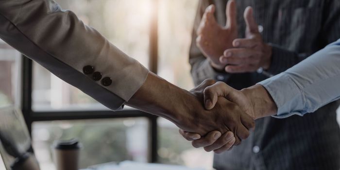 Business handshake for teamwork of business merger and acquisition,successful negotiate,hand shake,two businessman shake hand with partner