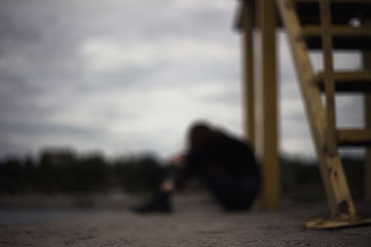 girl bullying loneliness teenager alone in solitude trying isolation to cope with anger and find strength in the evening gloomy photo abandonment thinking about fate is not easy and hard mooring at the pier. High quality photo