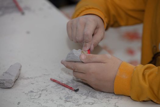 children's entertainment, a child plays in an archaeologist, children's hands dig dinosaur bones