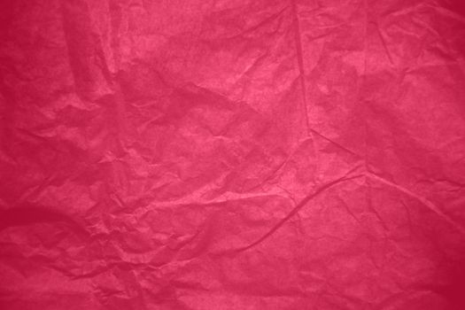 Crumpled paper Viva Magenta color of the year 2023. Texture crumpled paper for your design. Copy space. Viva Magenta color paper. High quality photo