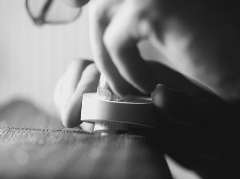 violinmaker working on a handmade contemporary stringed instrument scroll