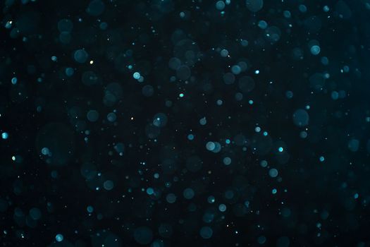 Abstract real dust particles on black background. Glittering sparkling bokeh overlay design with copy space for text. High quality photo