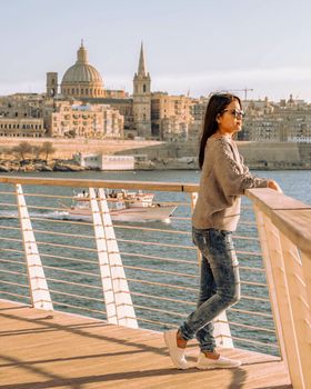 Valletta Malta city Skyline, colorful house balcony Malta Valletta city, young Asian woman visit Malta during a vacation