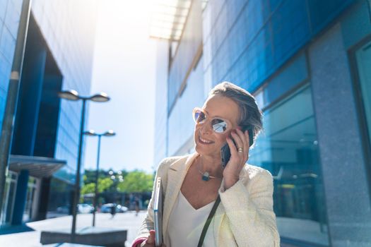 Businesswoman smiling talking with her smart phone. High quality photo