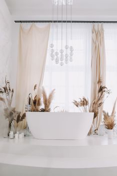 Modern white bathroom. White bath in a room with white walls. Interior design.