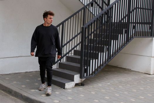 A man walks down a concrete staircase.