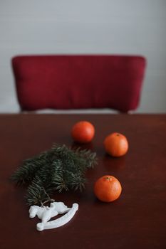 Christmas Toy horse, tangerines and pine cone. Winter holiday items for home decor. Flat lay stock photography.