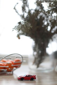 Christmas tree and toy car. Christmas holiday celebration concept.