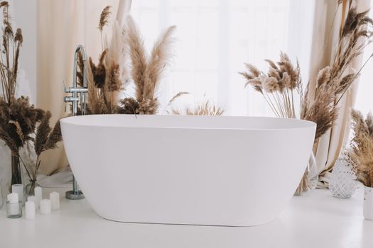 Modern white bathroom. White bath in a room with white walls. Interior design.