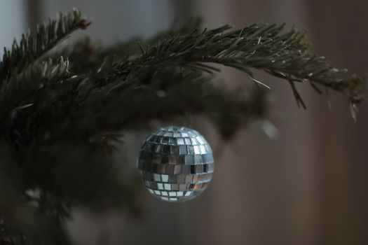 Christmas composition. New Year background - baubles and branch of spruce tree. Christmas decoration hanging on tree.