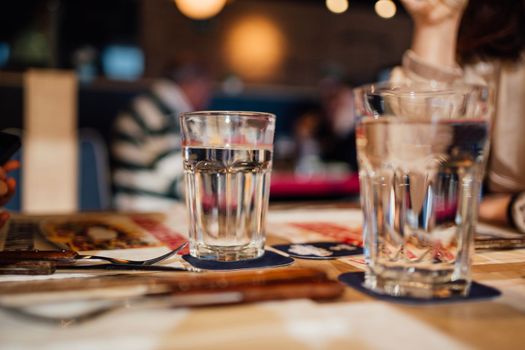 background blurred restaurant table setting with people enjoying.