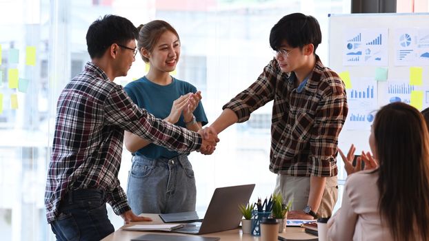 Cropped image business people shaking hands for successful agreement or after meeting in office.