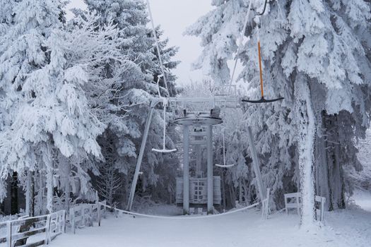 Ski lift station in the snow in the winter forest on the Wasserkuppe mountain in Rhen, Hesse, Germany. High quality photo