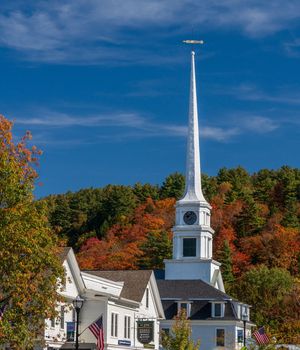 Stowe, VT - 6 October 2022: Steeple of Stowe Community Church set against fall colors
