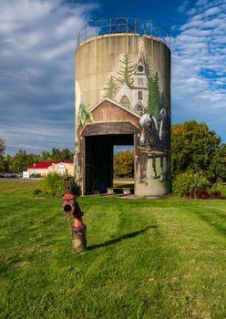 Jefferson, VT - 1 October 2022: Mural by Sarah Rutherford on concrete silo representing the seasons