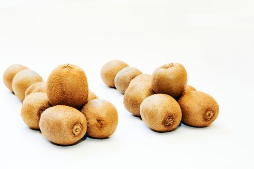 a flightless New Zealand bird with hairlike feathers, having a long down-curved bill with sensitive nostrils at the tip. Several ripe tasty kiwis isolated on white.