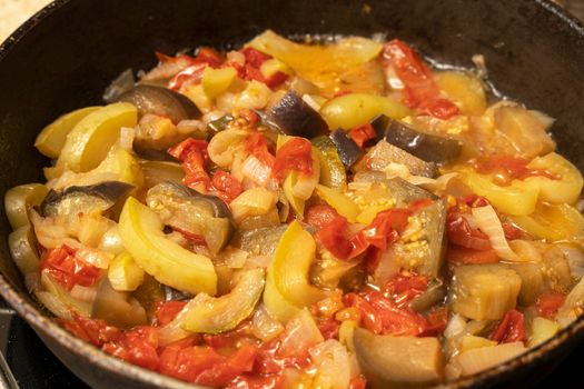 delicious juicy hot vegetable stew. ratatouille is cooked in a frying pan. High quality photo