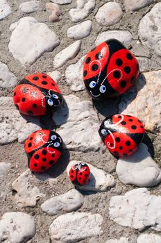 beautiful garden decor red ladybugs painted on stones. High quality photo