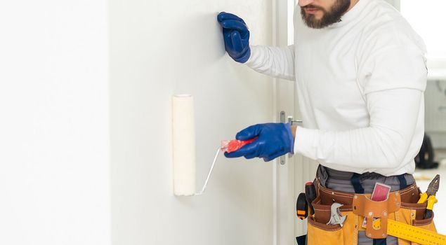 Male with belt full of hand instruments for repairing home