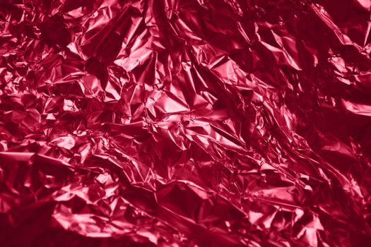 Texture foil Viva Magenta color. Background for your design. Crumpled colored Viva Magenta foil. High quality photo