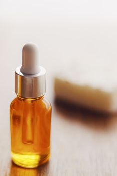 Oil serum bottle and natural soap, beauty and skincare product.