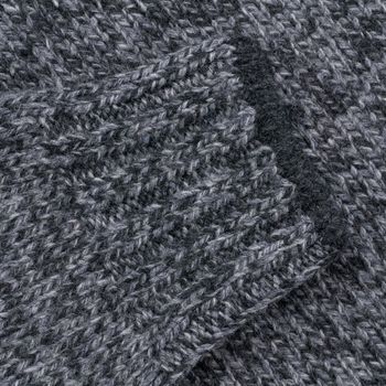 Grey melange wool sweater sleeve close up background