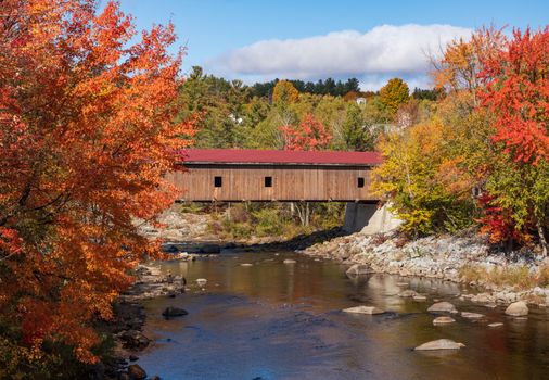 Colorful fall trees in the Adirondacks around Jay covered bridge in New York State in the autumn