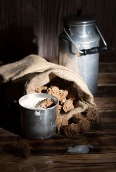 still life with dark style milk in an aluminum mug with crackers and a can. High quality photo