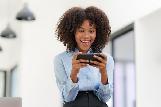 Business black woman having phone conversation with client in office. Woman reading news, report or email. Online problem, finance mistake, troubleshooting.