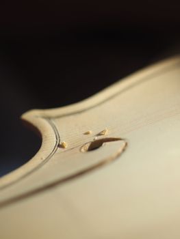 violinmaker cutting and sawing golden period cremonese violin model fholes with a blade with precision