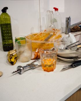 Pile of dirty utensils in a kitchen after party or dinner that should be cleaned.