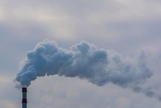 Smoke Emerging From Chimney Against The Sky. Dyrty smoke. Smoke pollution of the environment.