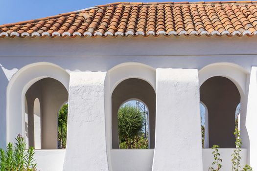 White walls and red tile roof of an old catholic church in Portugal