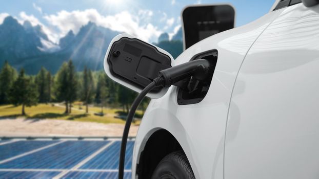 Concept of progressive future renewable and clean energy technology by charging station recharge EV car's battery powered by solar cell for eco-friendly sustainable energy system.