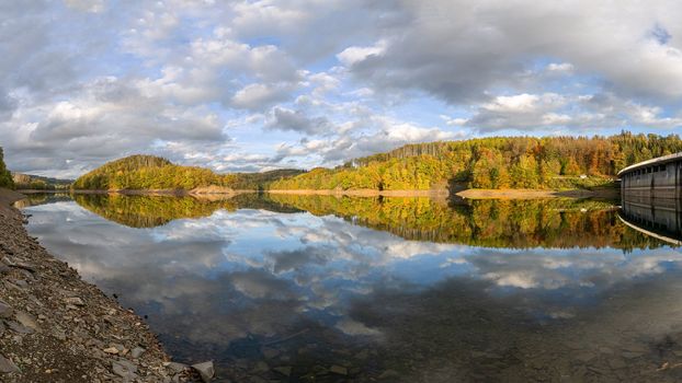 Panoramic image of Agger lake close to Gummersbach in evening light during autumn, Bergisches Land, Germany