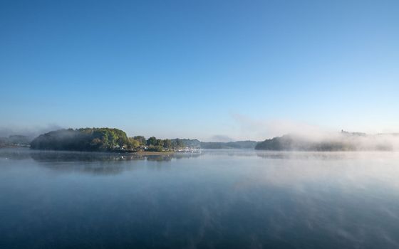 Panoramic image of Bever lake close to Huckeswagen on a foggy morning, Bergisches Land, Germany