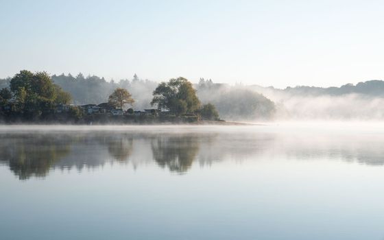 Panoramic image of Bever lake close to Huckeswagen on a foggy morning, Bergisches Land, Germany