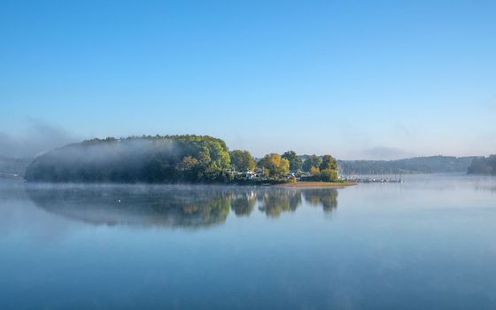 Panoramic image of Bever lake close to Huckeswagen on a foggy morning, Bergisches Land, Germany