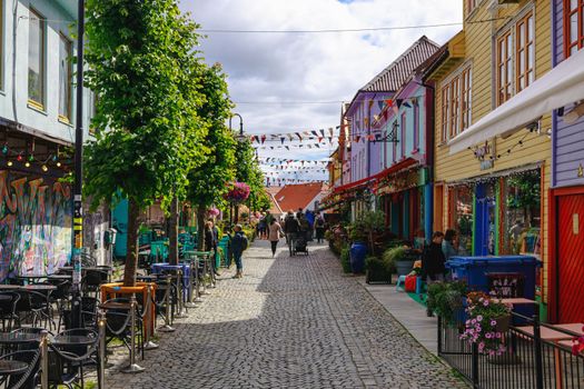 Stavanger, Norway - July 16 2022. View of Fargegaten (means Street of Colours), the famous colourful pedestrian street with shops and plenty of places for coffee and drinks