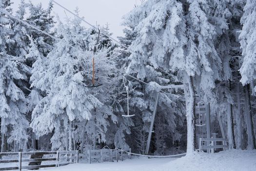 Ski lift station in the snow in the winter forest on the Wasserkuppe mountain in Rhen, Hesse, Germany. High quality photo