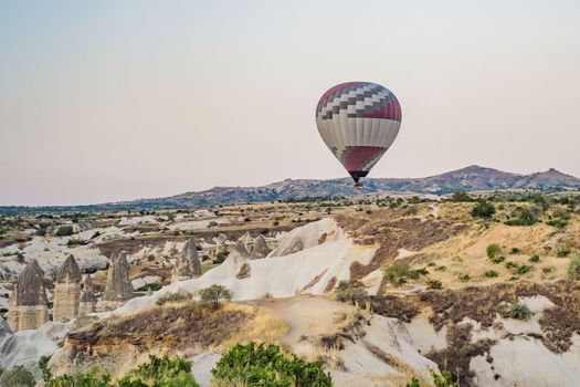 Colorful hot air balloon flying over Cappadocia, Turkey.