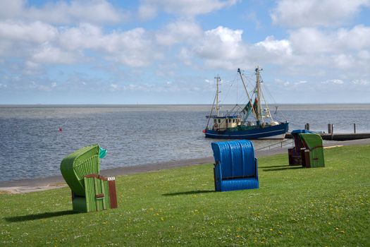 Panoramic image of the landscape along the dikes of Pellworm with beach chairs, North Frisia, Germany 
